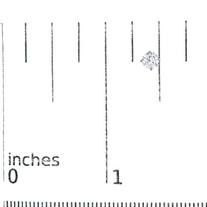 Single white metal stud earring with a round white gemstone in a 4-prong setting, shown on a scale from a side angle.