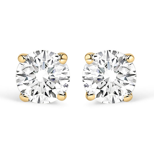 Front view of yellow metal stud earrings with round white gemstones in four-prong settings.