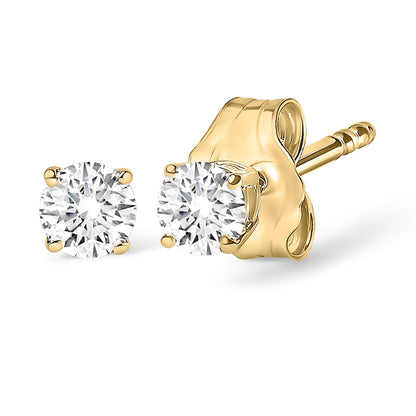 Close-up front and side angled view of yellow metal stud earrings with round white gemstones in 4-prong settings.