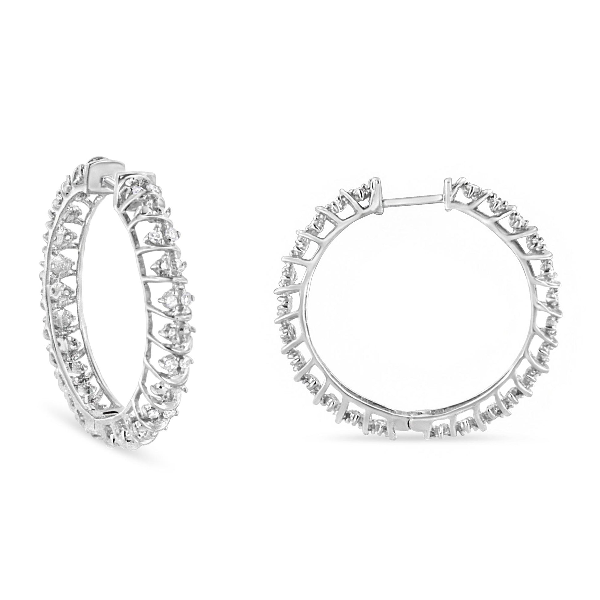 Pair of white metal hoop earrings with round white gemstones in prong settings, shown from a front and angled side view on a white background.