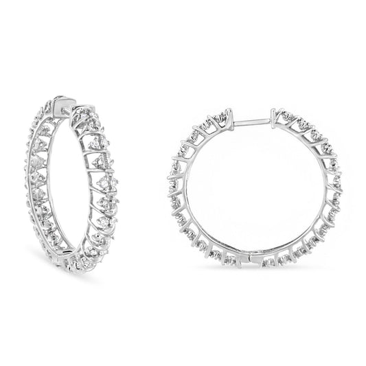 Pair of white metal hoop earrings with round white gemstones in prong settings, shown from a front and angled side view on a white background.