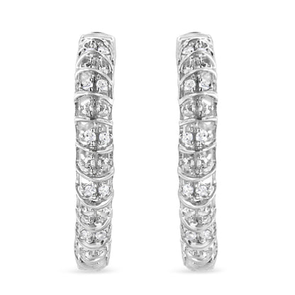 Front-facing view of a pair of white metal hoop earrings adorned with multiple round white gemstones in prong settings.