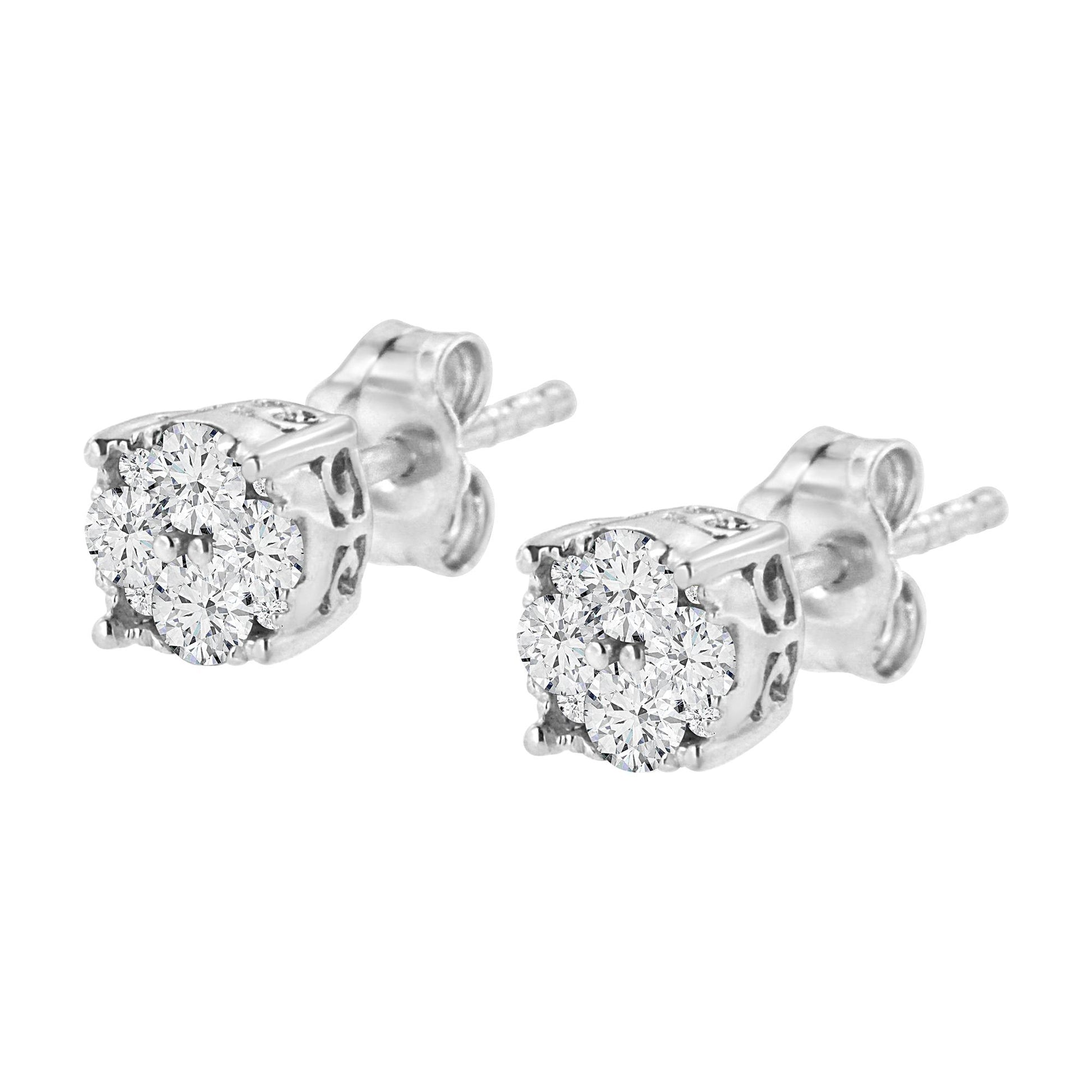 Close-up front angle of a pair of white metal stud earrings with cluster settings featuring multiple white round gemstones.