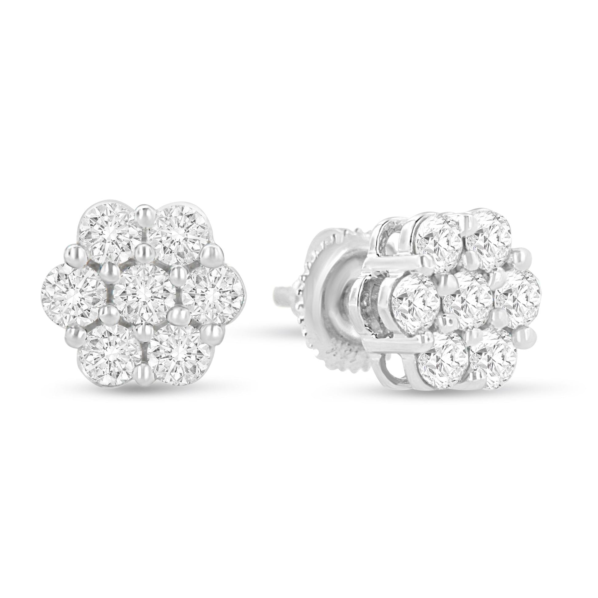 Pair of white metal flower-shaped stud earrings with round white gemstones in prong settings, shown from front and side angles on a white background.