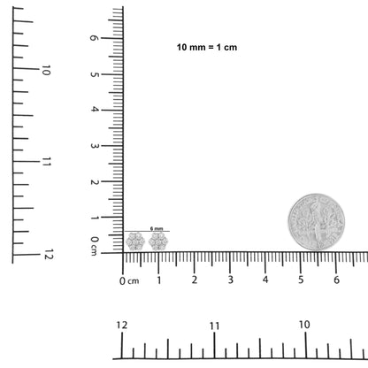 Pair of white metal cluster earrings with multiple round white gemstones in prong settings, shown at front angle on a ruler and scale with a dime for size reference.