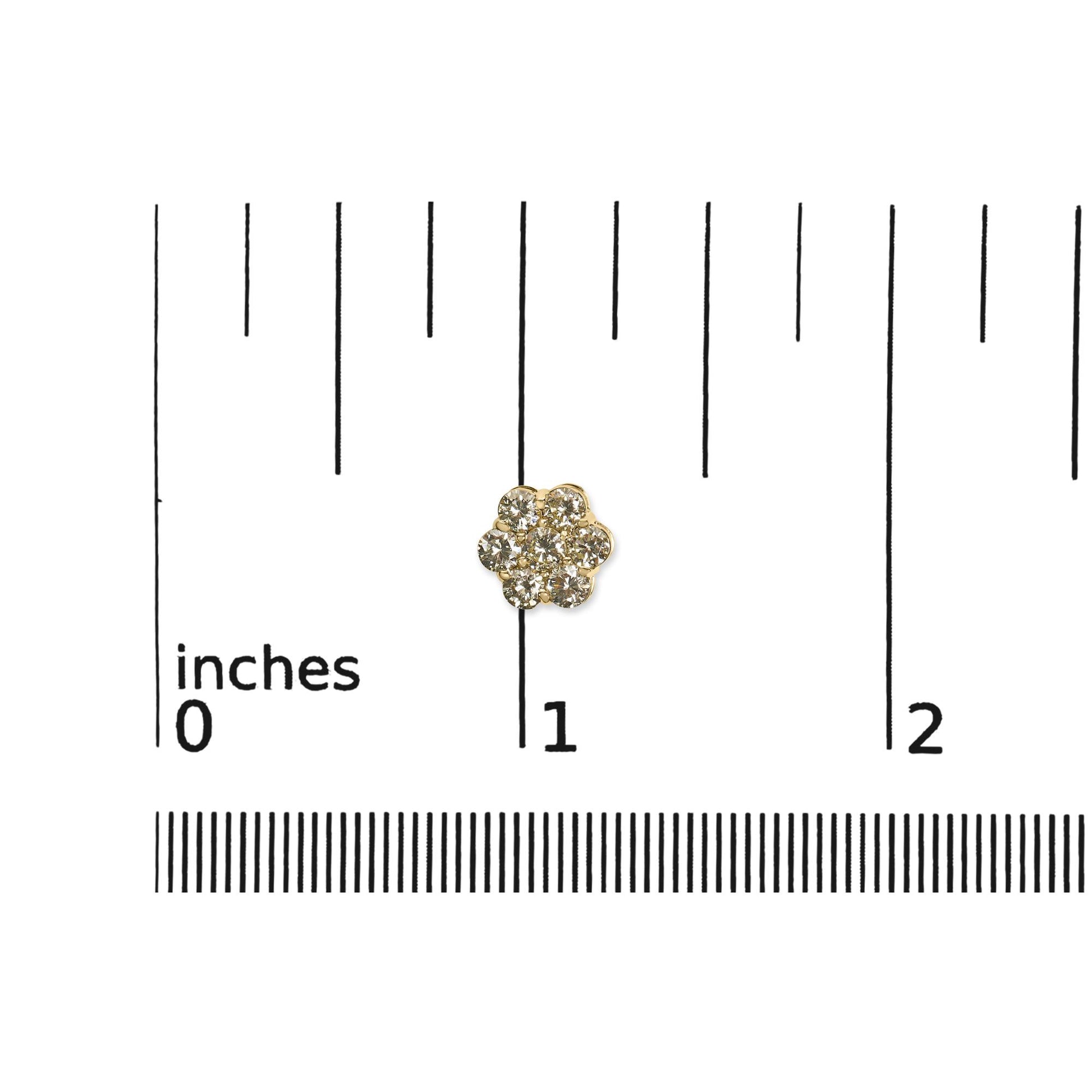 Close-up top view of a yellow metal earring with round white gemstones in prong settings arranged in a cluster, placed on a ruler for size reference.
