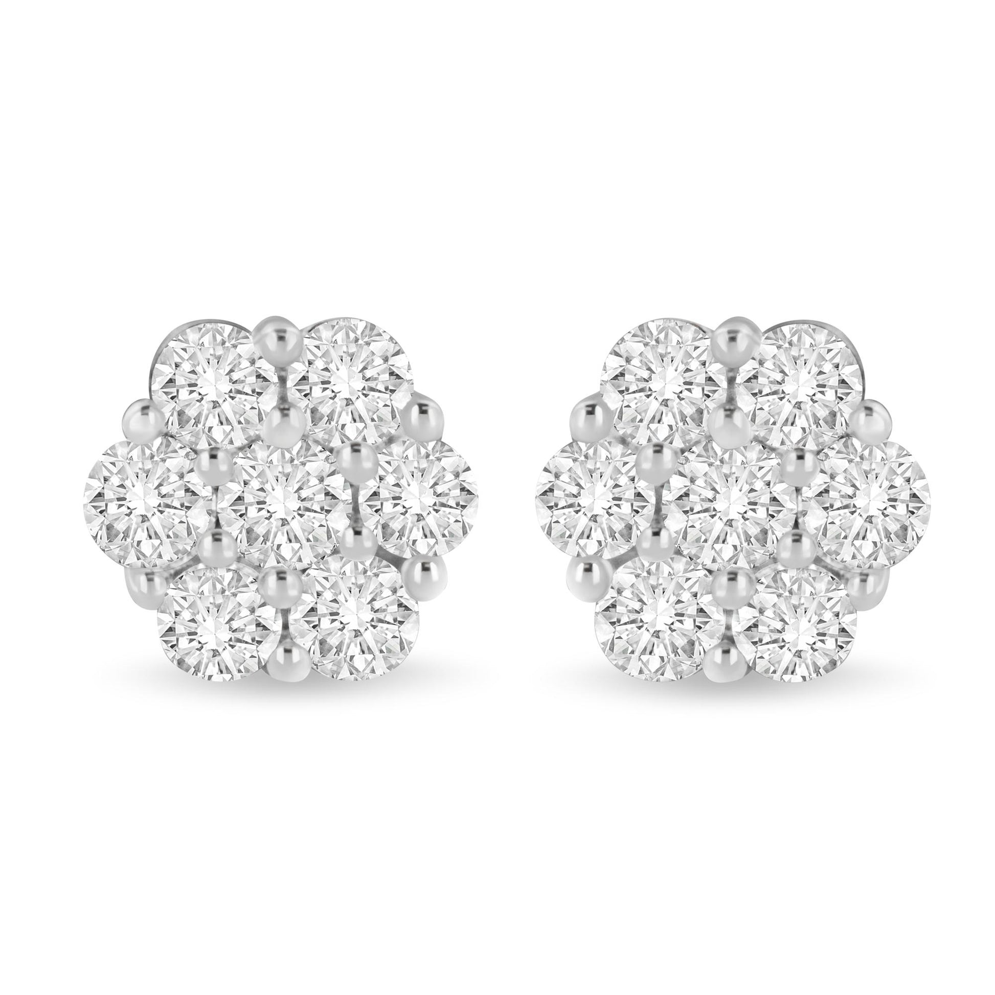 Pair of white metal cluster earrings with round white gemstones in shared prong setting, front view.