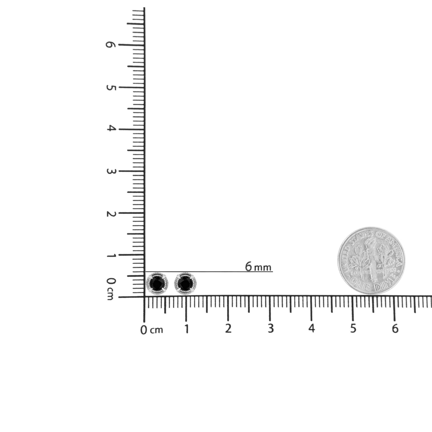 White metal stud earrings with round white gemstones in prong settings, shown on a ruler for size reference, top-down view.