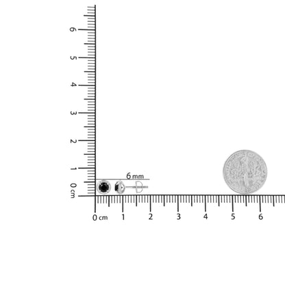 Pair of white metal stud earrings with round black gemstones in prong settings, shown from front and side angles on a ruler for size reference.