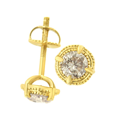 Close-up front and side view of yellow metal stud earrings with round brownish prong-set gemstones.