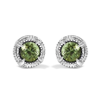 Front-facing shot of a pair of white metal stud earrings, each featuring a round prong-set green gemstone surrounded by a textured circular border.