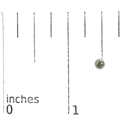 Close-up front view of white metal earring with a round green gemstone in prong setting, displayed on a ruler for size reference.