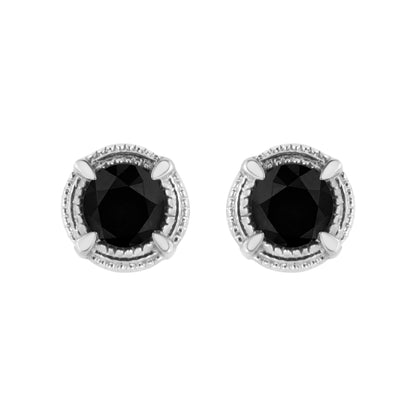 Top-down view of white metal stud earrings with round black gemstones in prong settings.