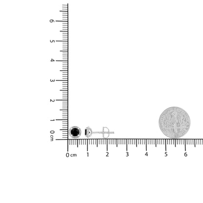 Pair of white metal stud earrings with round black gemstones in prong settings, shown from front and side on a ruler and scale for size reference.