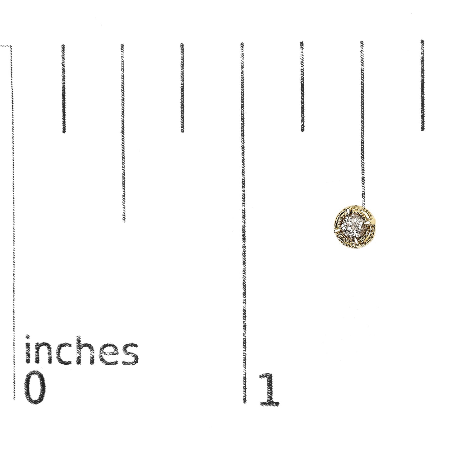 Close-up front angle of a yellow metal stud earring with a round brownish gemstone in a prong setting, placed on a ruler for size reference.