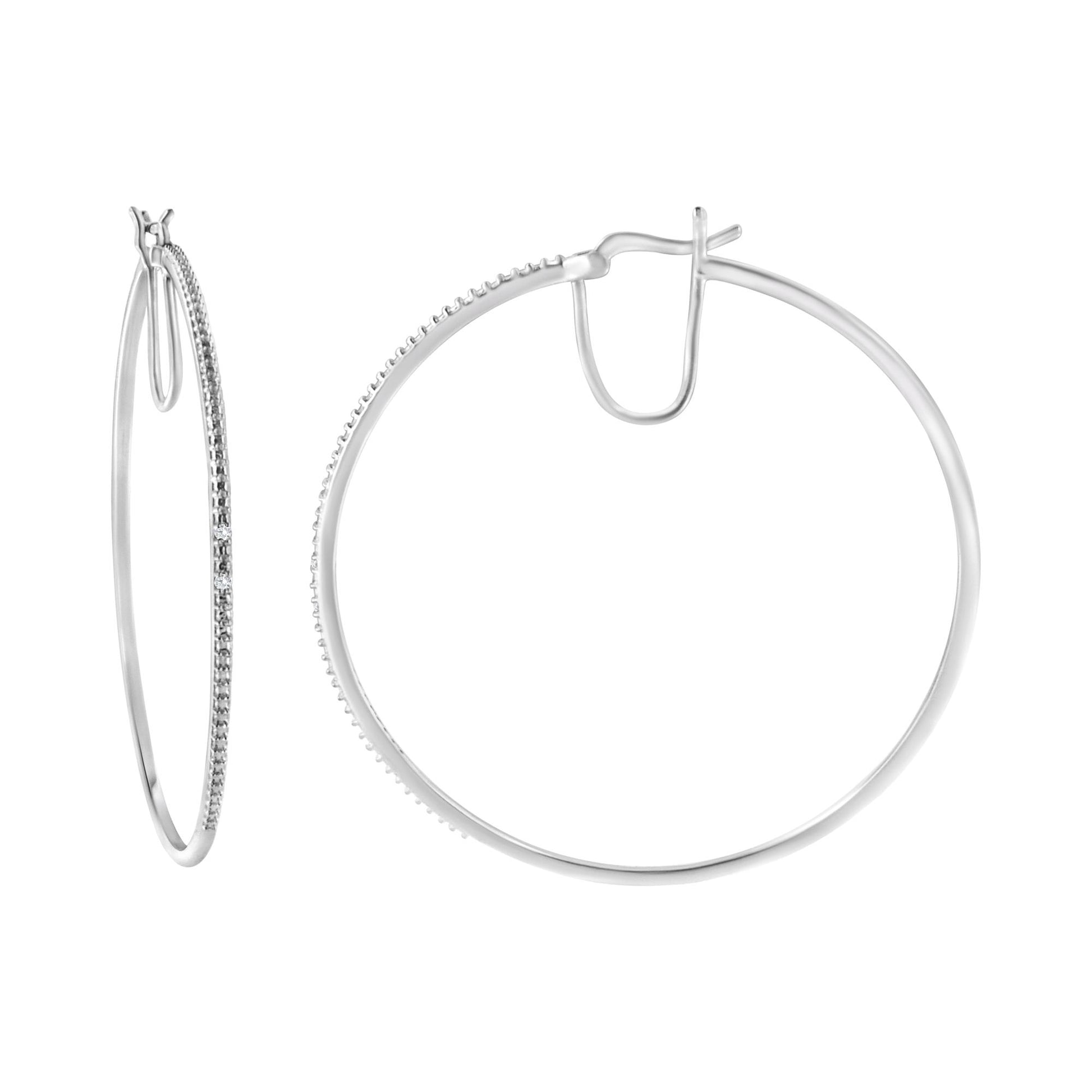 White metal hoop earrings with round white gemstones in prong settings along the front, shown from front and side angles on a white background.