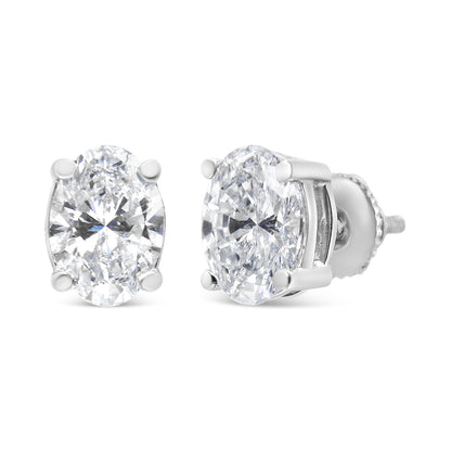 White metal stud earrings with oval-shaped white gemstones in four-prong settings, shown from front and side angles.