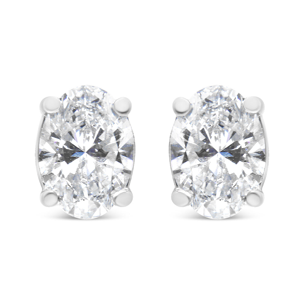 Front view of a pair of white metal earrings featuring oval-shaped white gemstones in 4-prong settings.