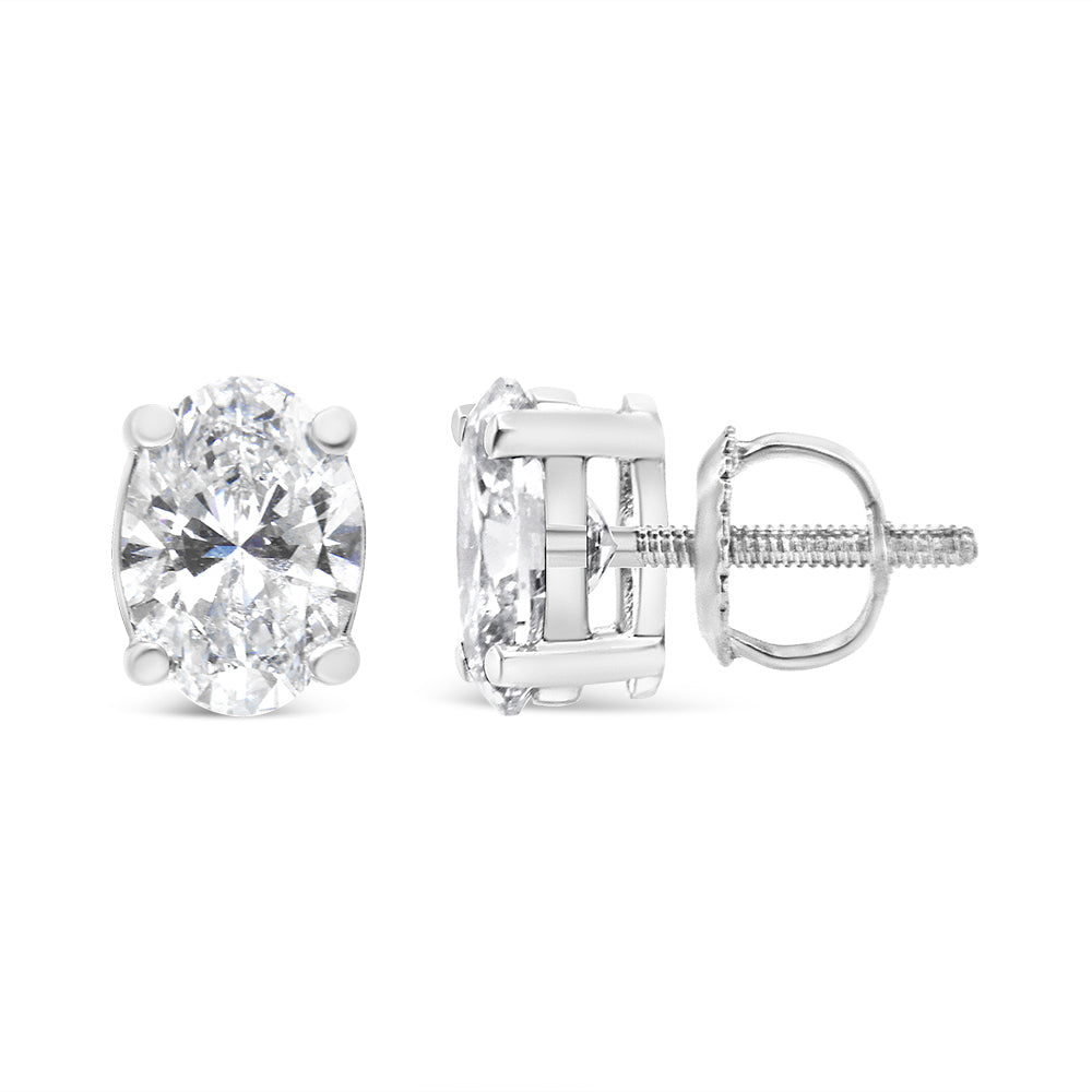 Pair of white metal stud earrings with oval-shaped white gemstones in 4-prong settings, shown from front and side angles.