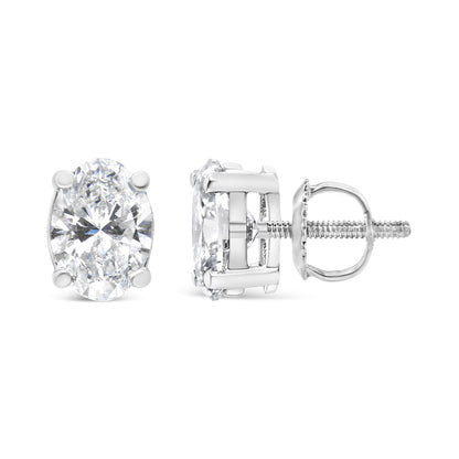 Pair of white metal stud earrings with oval-shaped white gemstones in 4-prong settings, shown from front and side angles.