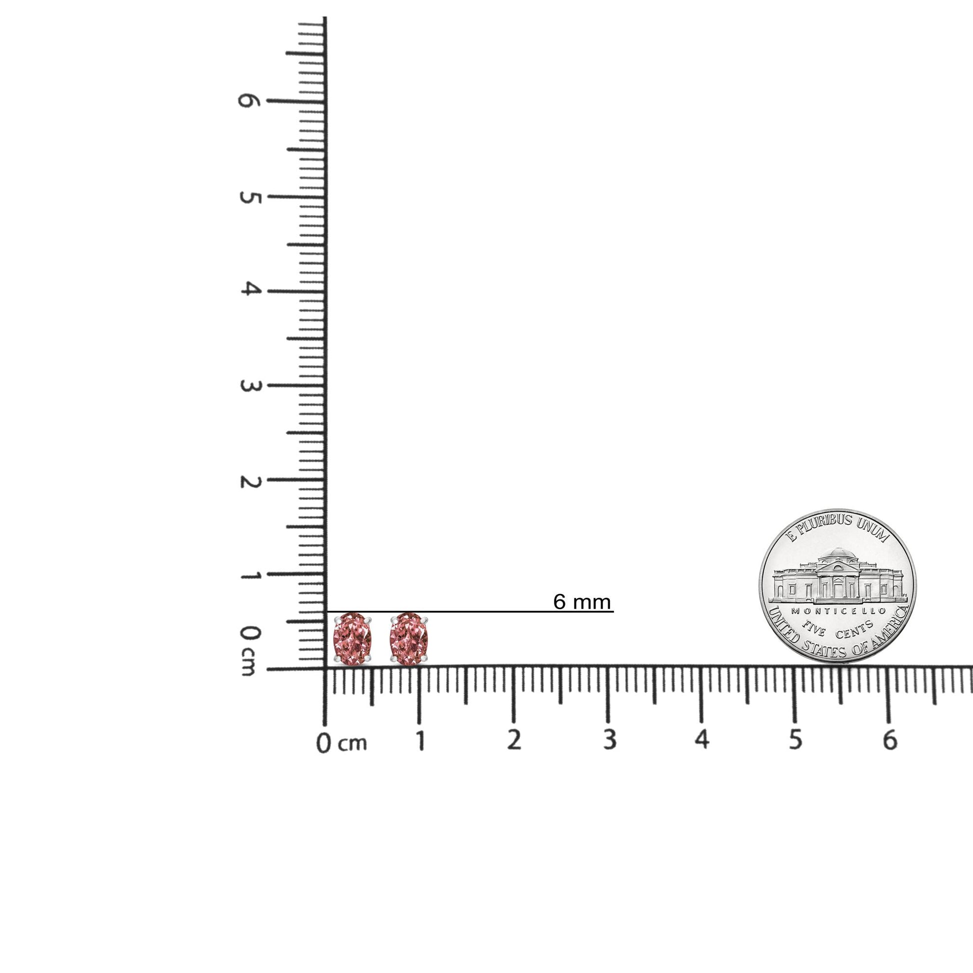 Pair of white metal earrings with oval pink gemstones in four-prong settings, shown on a ruler and scale for size reference, front angle.