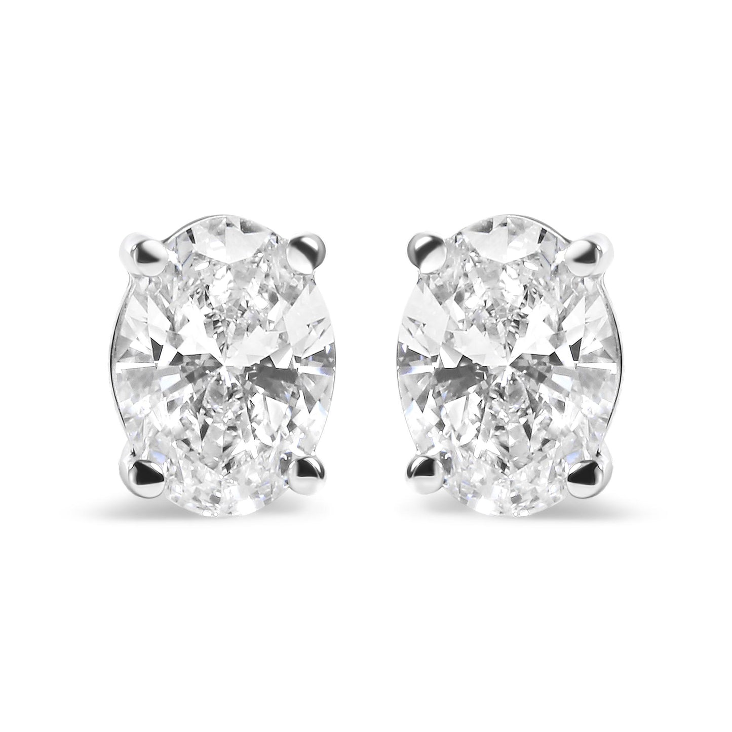 Front view of white metal stud earrings featuring oval-shaped white gemstones in a four-prong setting.