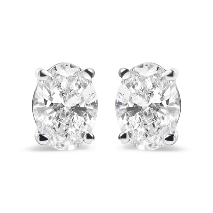 Front view of white metal stud earrings featuring oval-shaped white gemstones in a four-prong setting.