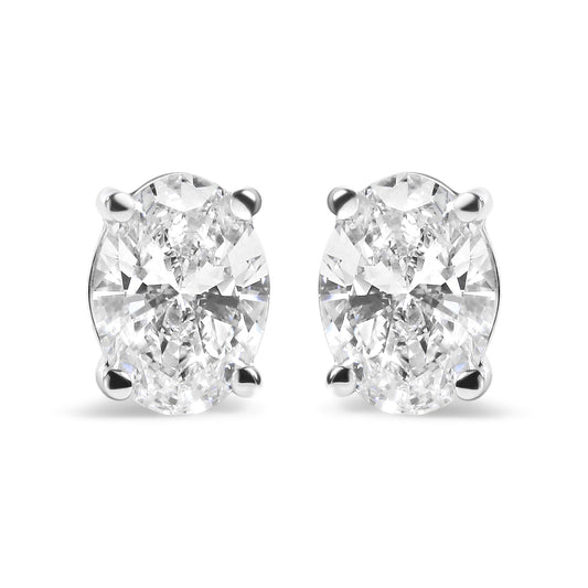 Front view of white metal stud earrings featuring oval-shaped white gemstones in a four-prong setting.