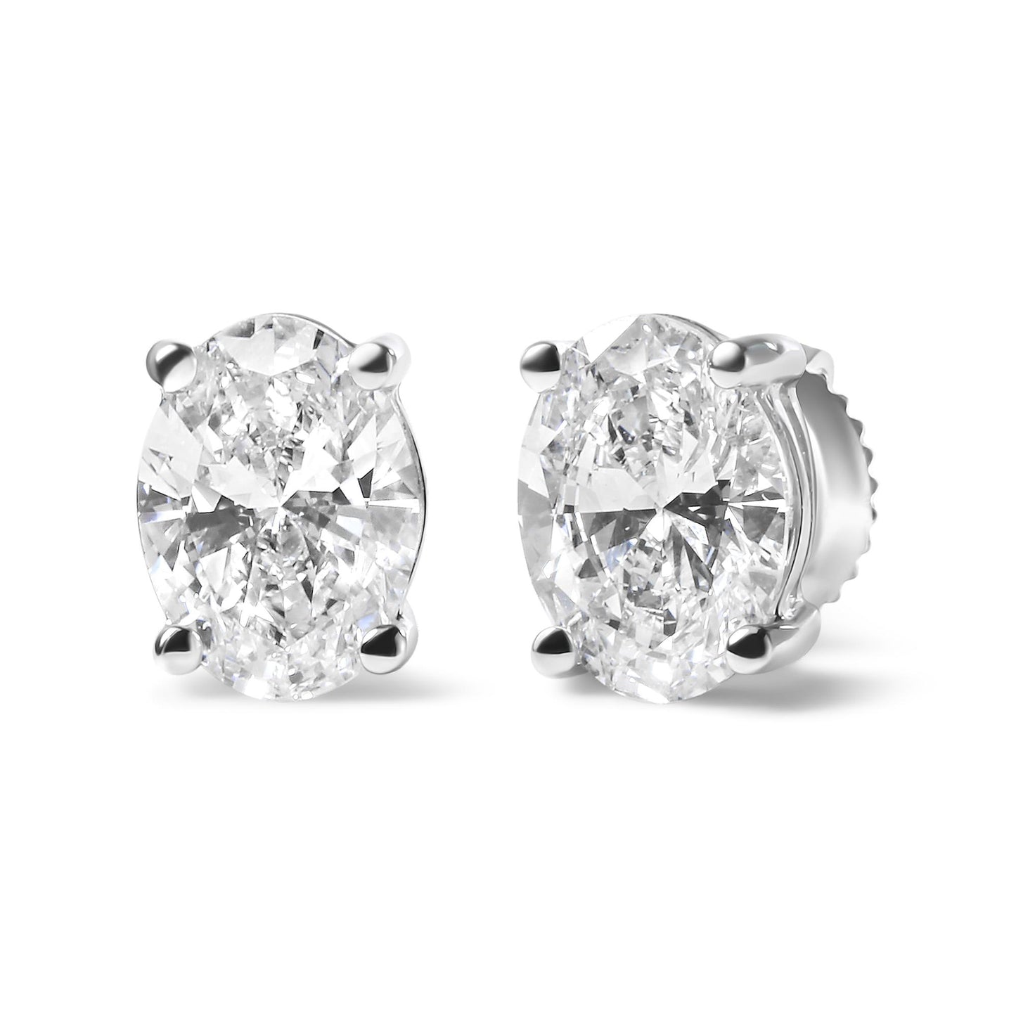 Pair of white metal stud earrings with oval-shaped white gemstones in four-prong settings, shown from a front-right angle.