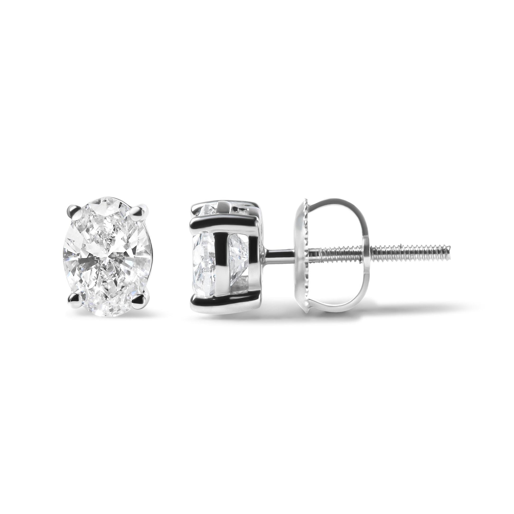 Pair of white metal stud earrings with oval-shaped white gemstones in 4-prong settings, shown from front and side angles on a white background.