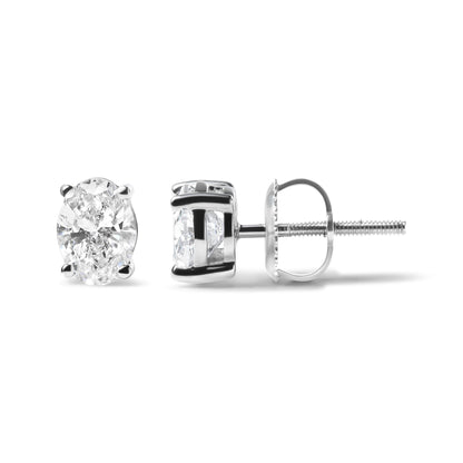 Pair of white metal stud earrings with oval-shaped white gemstones in 4-prong settings, shown from front and side angles on a white background.