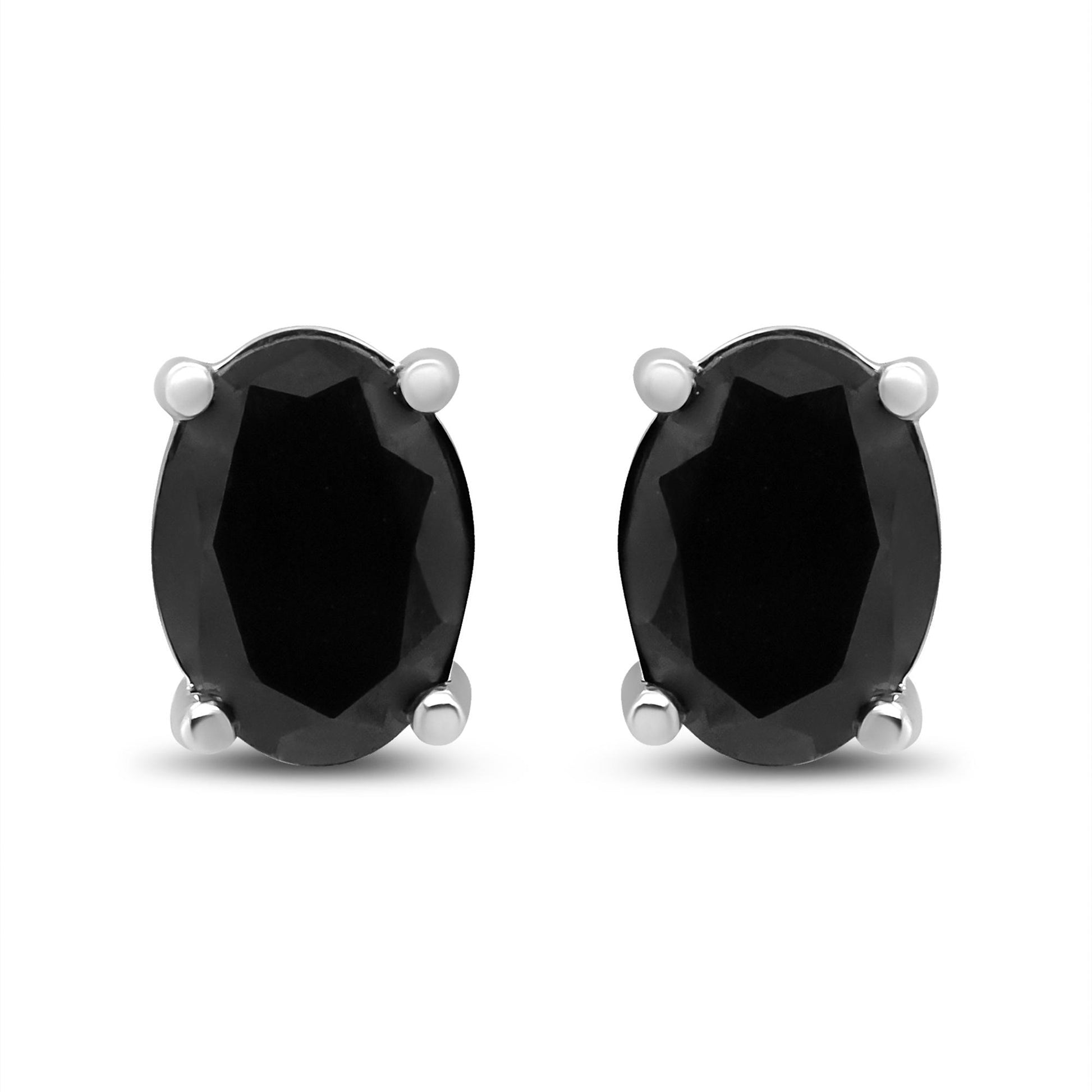 Front-facing view of white metal stud earrings featuring oval-shaped black gemstones in four-prong settings.