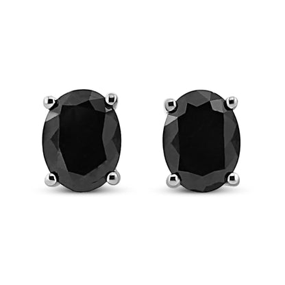Pair of white metal stud earrings with oval-shaped black gemstones in prong settings, front view.