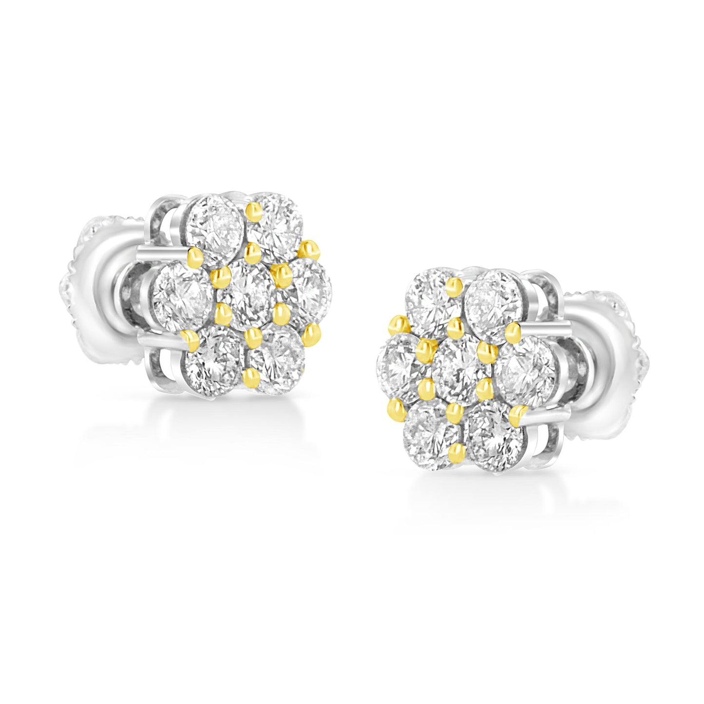 Pair of yellow metal earrings with round brownish prong-set gemstones, shown in a close-up shot from a side angle.