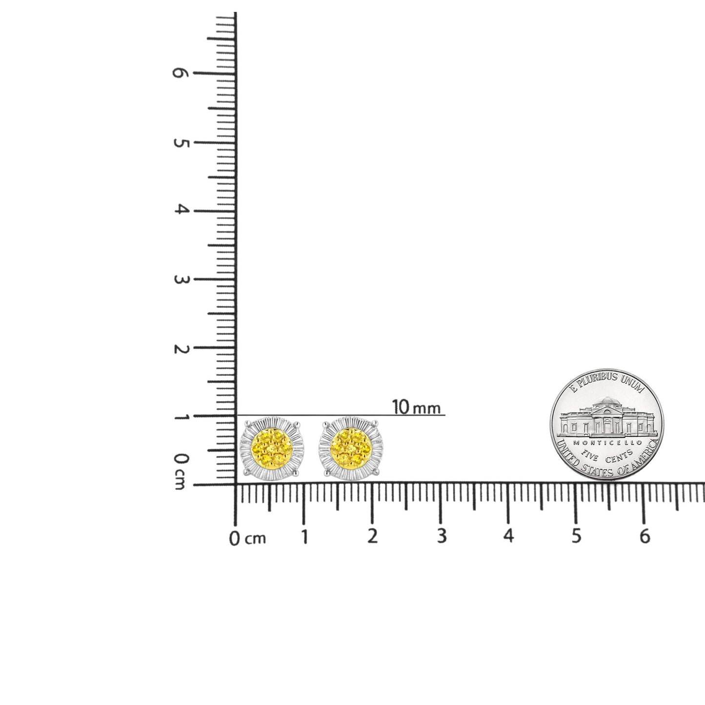 Pair of stud earrings with yellow round gemstones in the center surrounded by white metal prong setting, pictured on a ruler and coin for size reference, top-down angle.