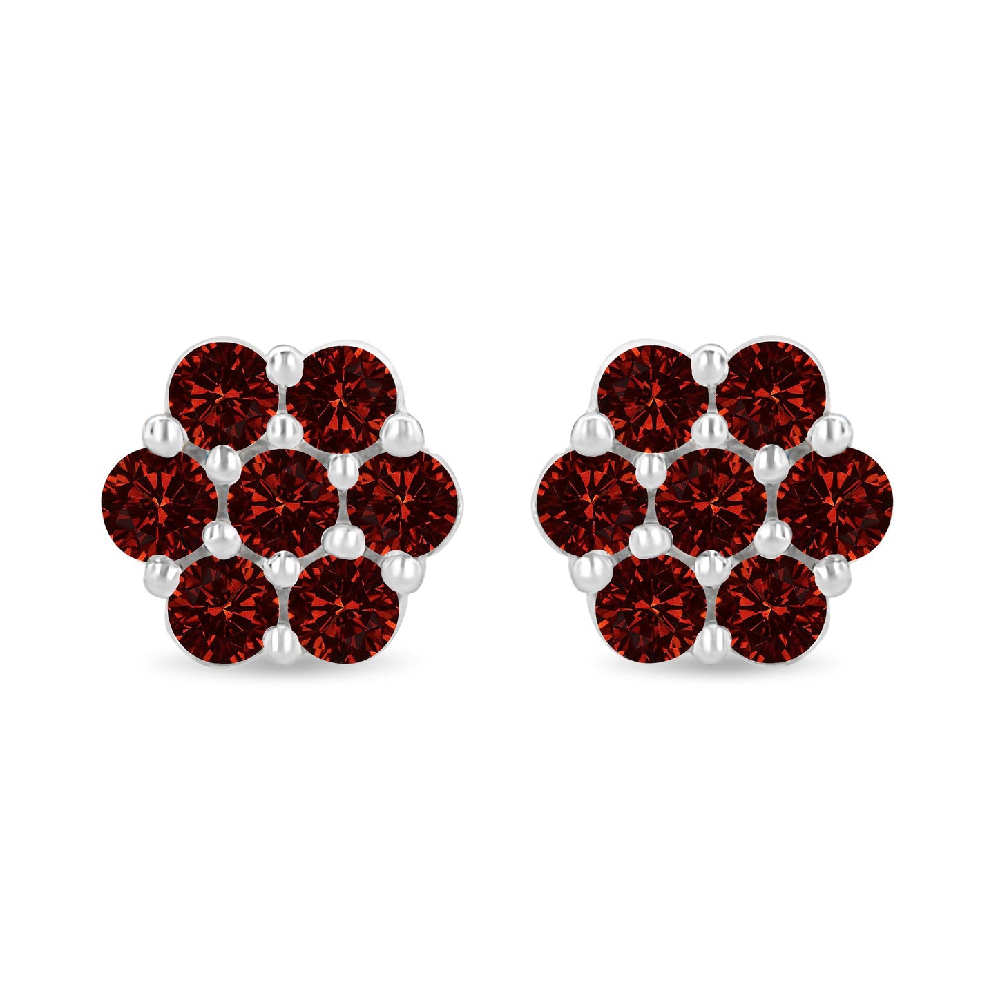 Pair of white metal earrings with round red gemstones in prong settings, front-facing shot.