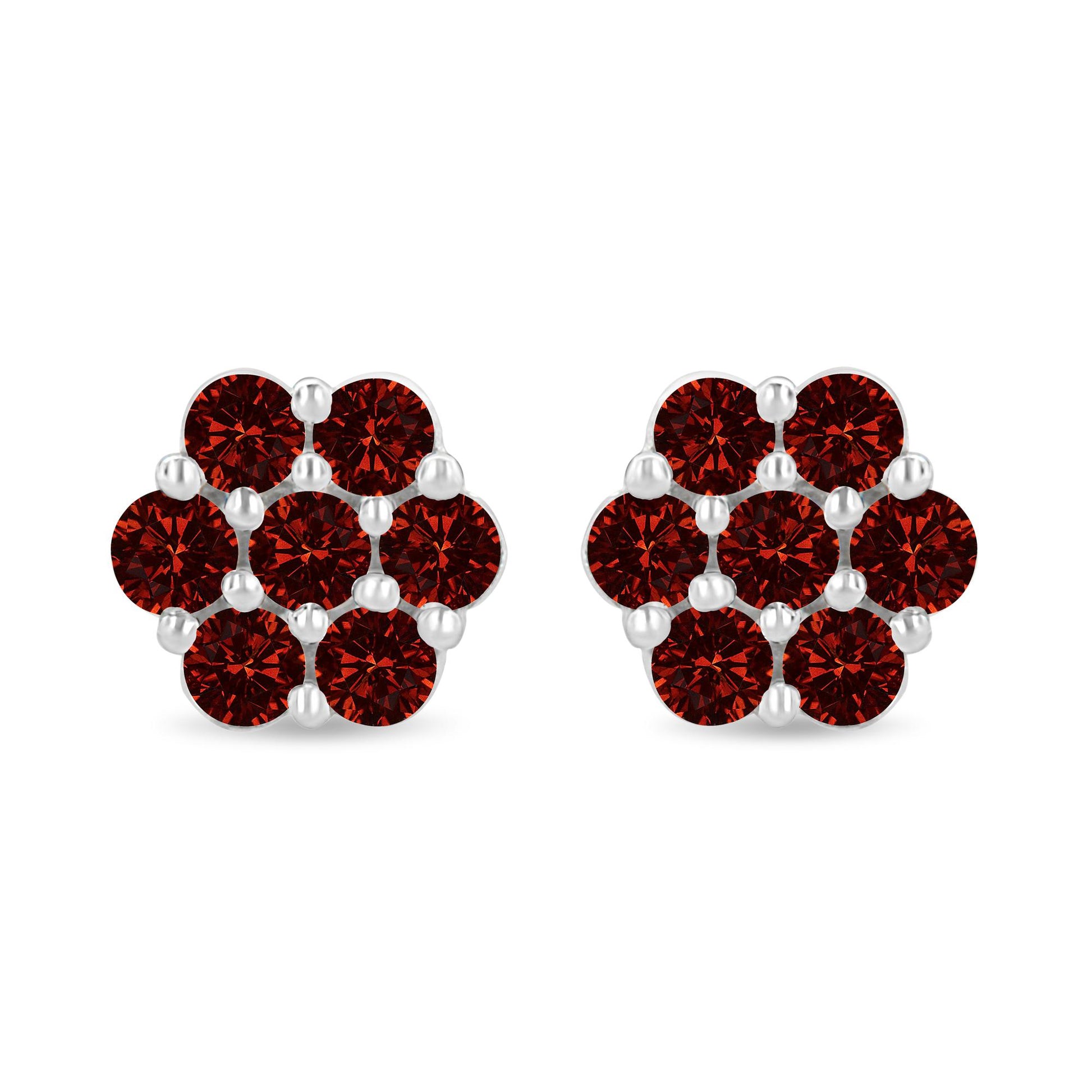 Pair of white metal earrings with round red gemstones in prong settings, front-facing shot.