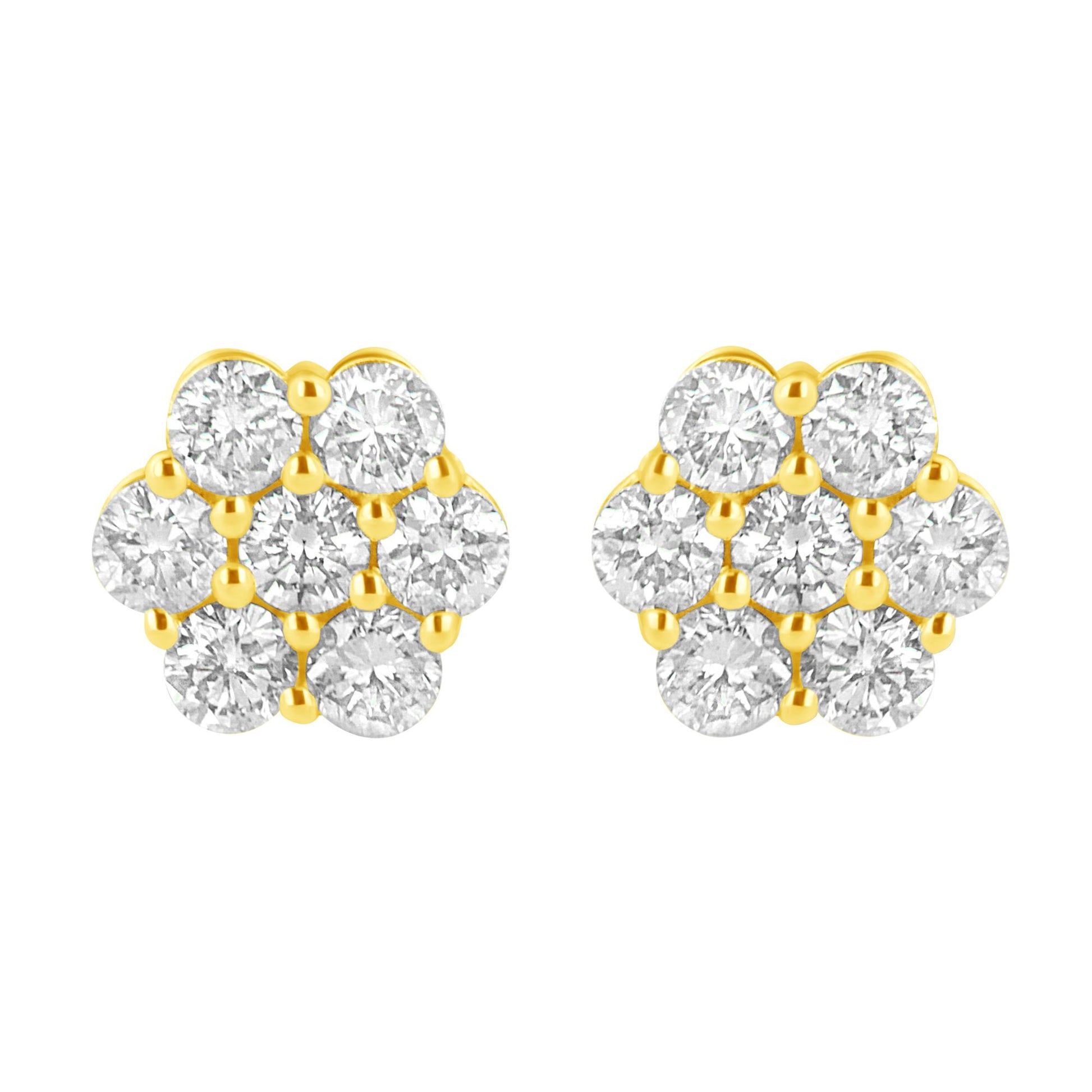 Front-facing close-up of a pair of yellow metal earrings designed with multiple round white gemstones in prong settings forming a clustered pattern.