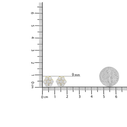 Pair of yellow metal flower-shaped earrings with round white gemstones in prong settings, shown from the front on a ruler for size reference.