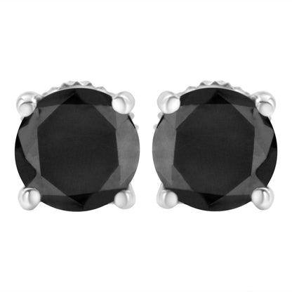 Close-up front view of a pair of white metal stud earrings with round black gemstones in prong settings.