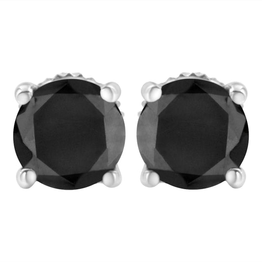 Close-up front view of a pair of white metal stud earrings with round black gemstones in prong settings.