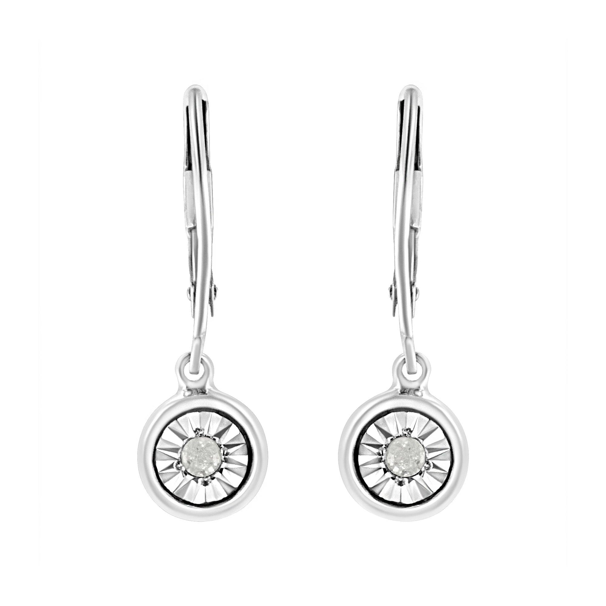 Front view of white metal drop earrings with round white gemstones set in a circular design.