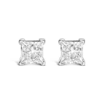Front-facing view of white metal stud earrings with princess-shaped clear gemstones in four-prong settings.