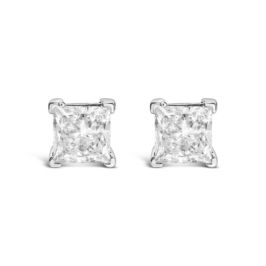 Front-facing view of white metal stud earrings with princess-shaped clear gemstones in four-prong settings.