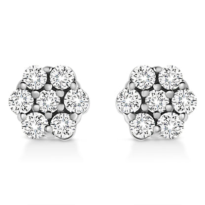 Front angle view of a pair of white metal earrings with round white gemstones in a cluster prong setting.