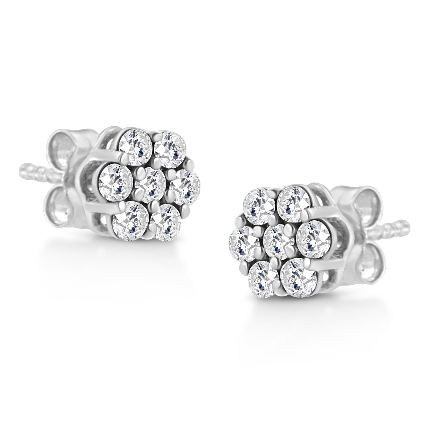 Pair of white metal stud earrings with round white gemstones in prong settings, shown at a slight angle.