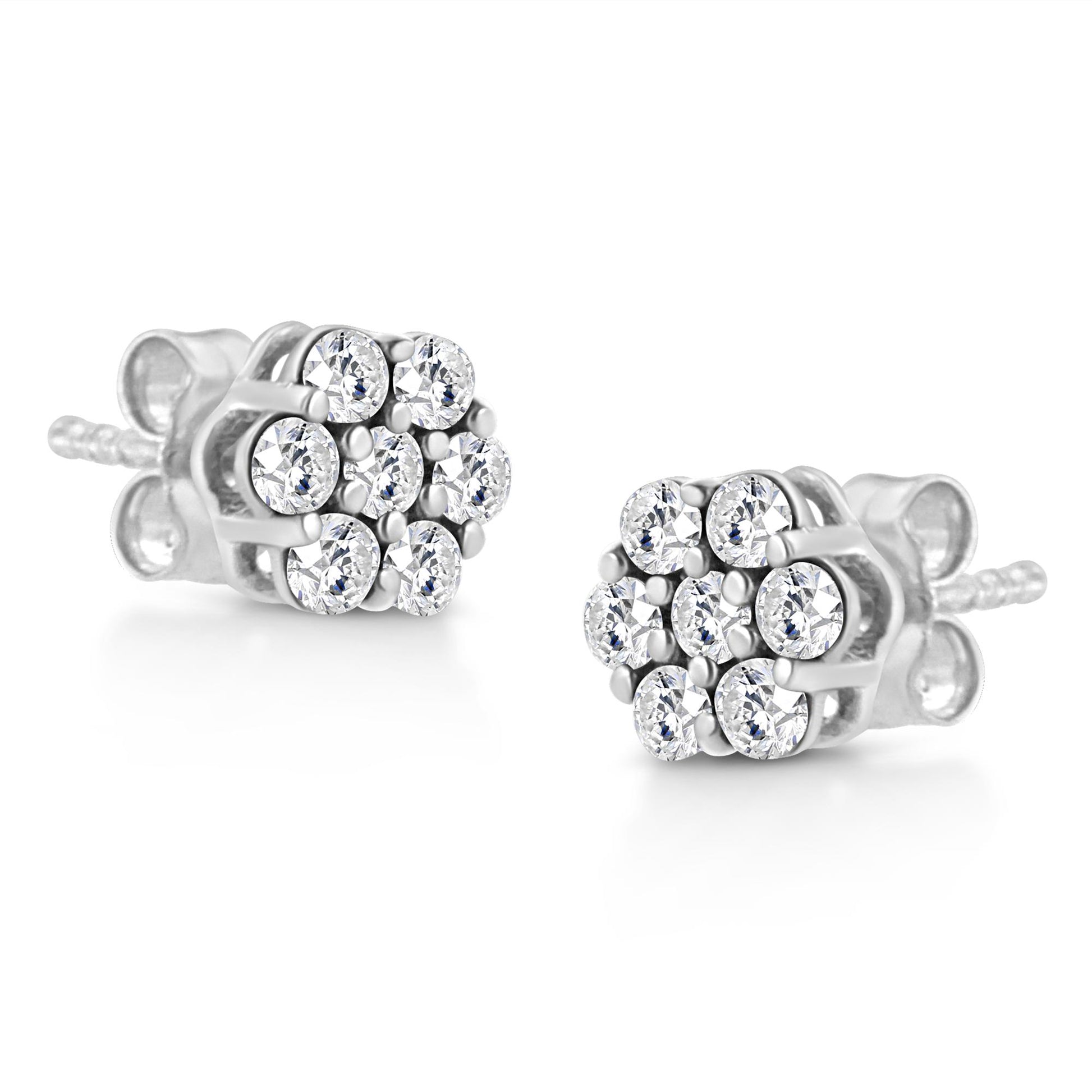 Pair of white metal stud earrings with round white gemstones in prong settings, shown at a slight angle.