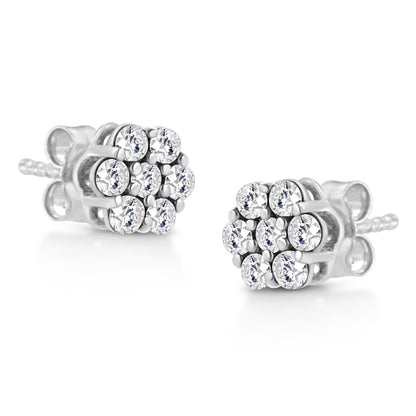 Pair of white metal stud earrings with round white gemstones in prong settings, shown at a slight angle.