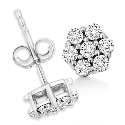 Close-up front and back view of white metal stud earrings with round white gemstones in prong settings.