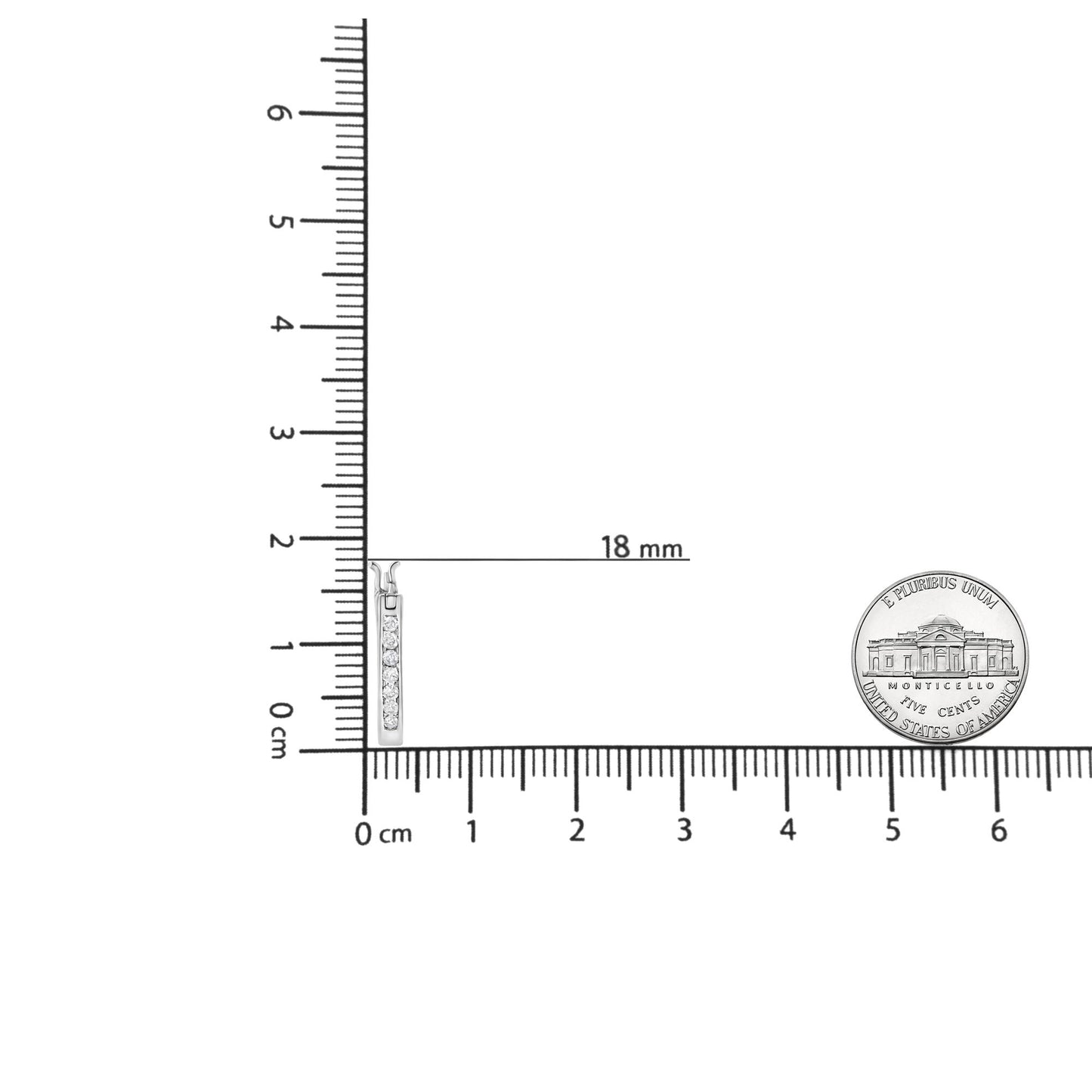 Earrings with white metal and round white gemstones in channel setting, displayed vertically next to ruler and coin for size reference, shot from the front.